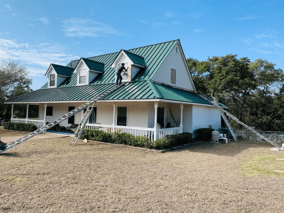 Ark worker installing a new metal roof on a Round Rock home