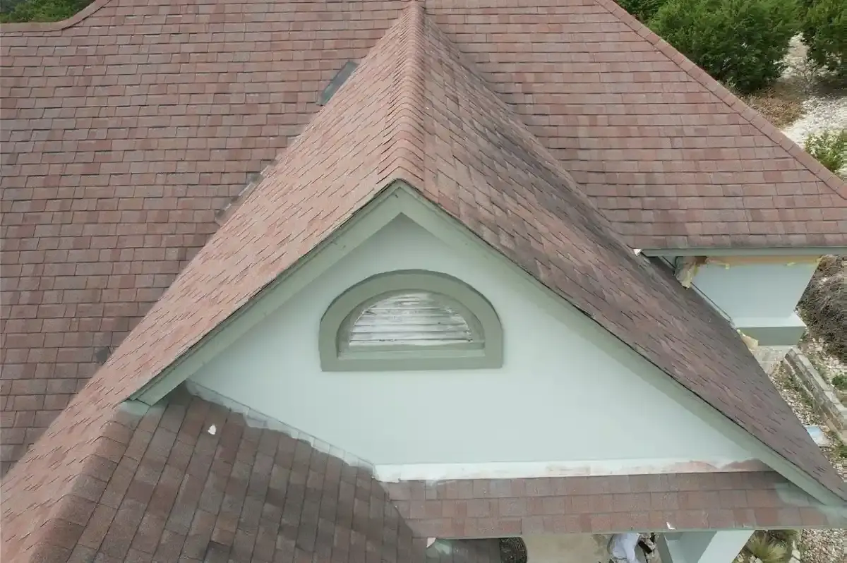 Brown shingle roof with a dormer vent on a Leander home