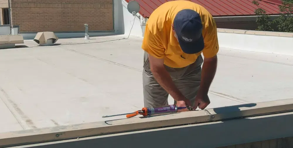 Ark technician servicing a commercial roof in Leander