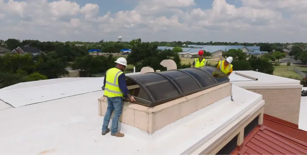 Ark crew installing a skylight on a Leander commercial roof