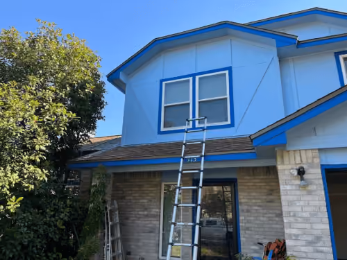 Blue siding and white trim on a home exterior