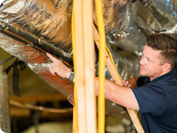 Ark technician measuring attic airflow in Leander