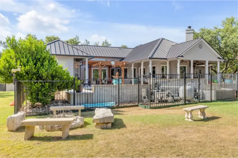 Central Texas home with a metal roof and pool where attic ventilation protects comfort and roof life
