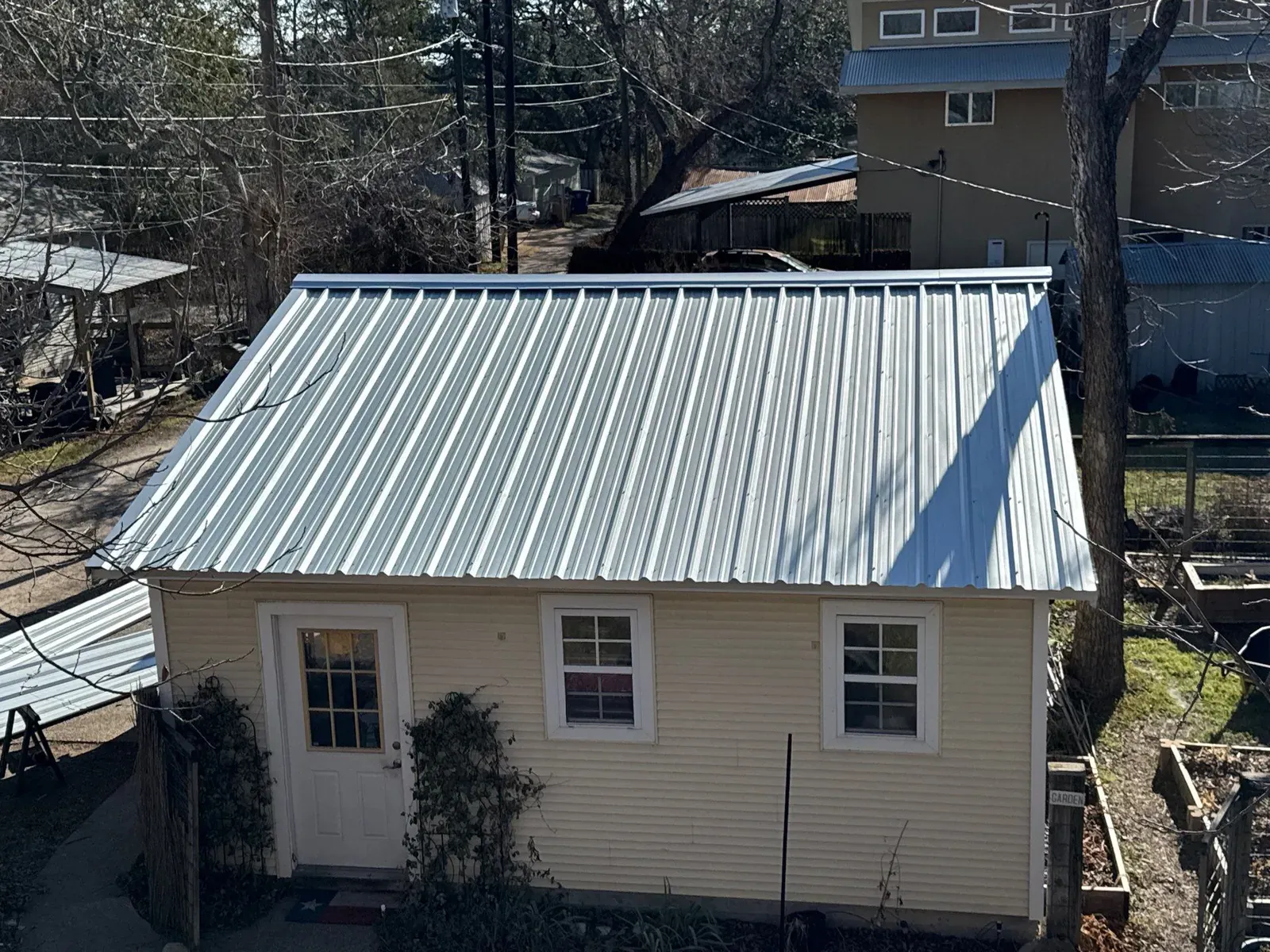 Cool metal roof installation showcasing R-Panel exposed-fastener corrugated steel design