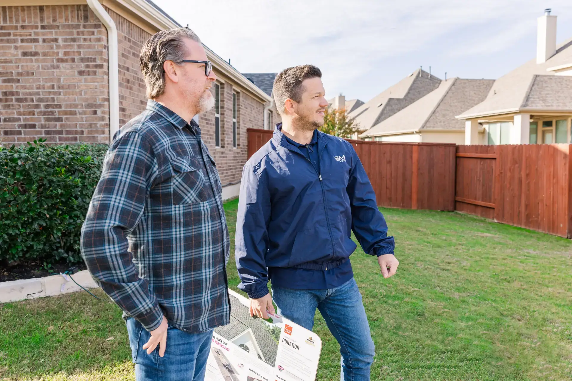 An Ark Roofer consultant reviewing roofing options with a homeowner in Central Texas