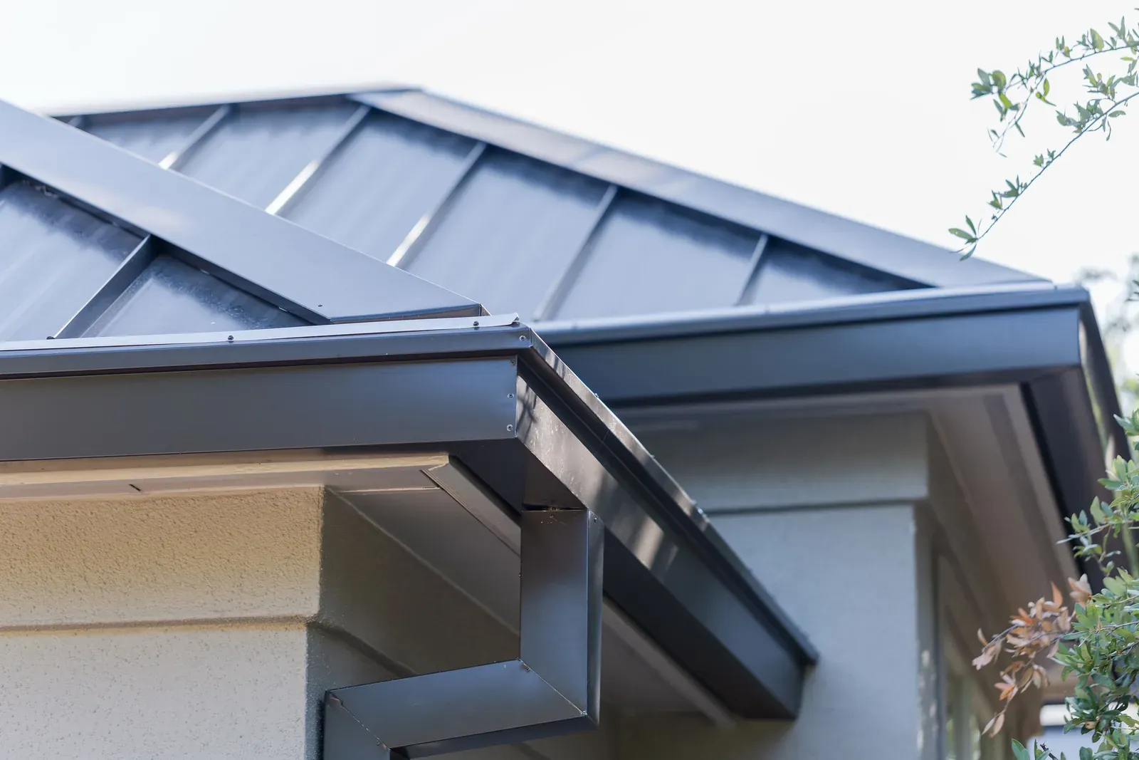 Seamless gutter and downspout carrying runoff away from a Central Texas home