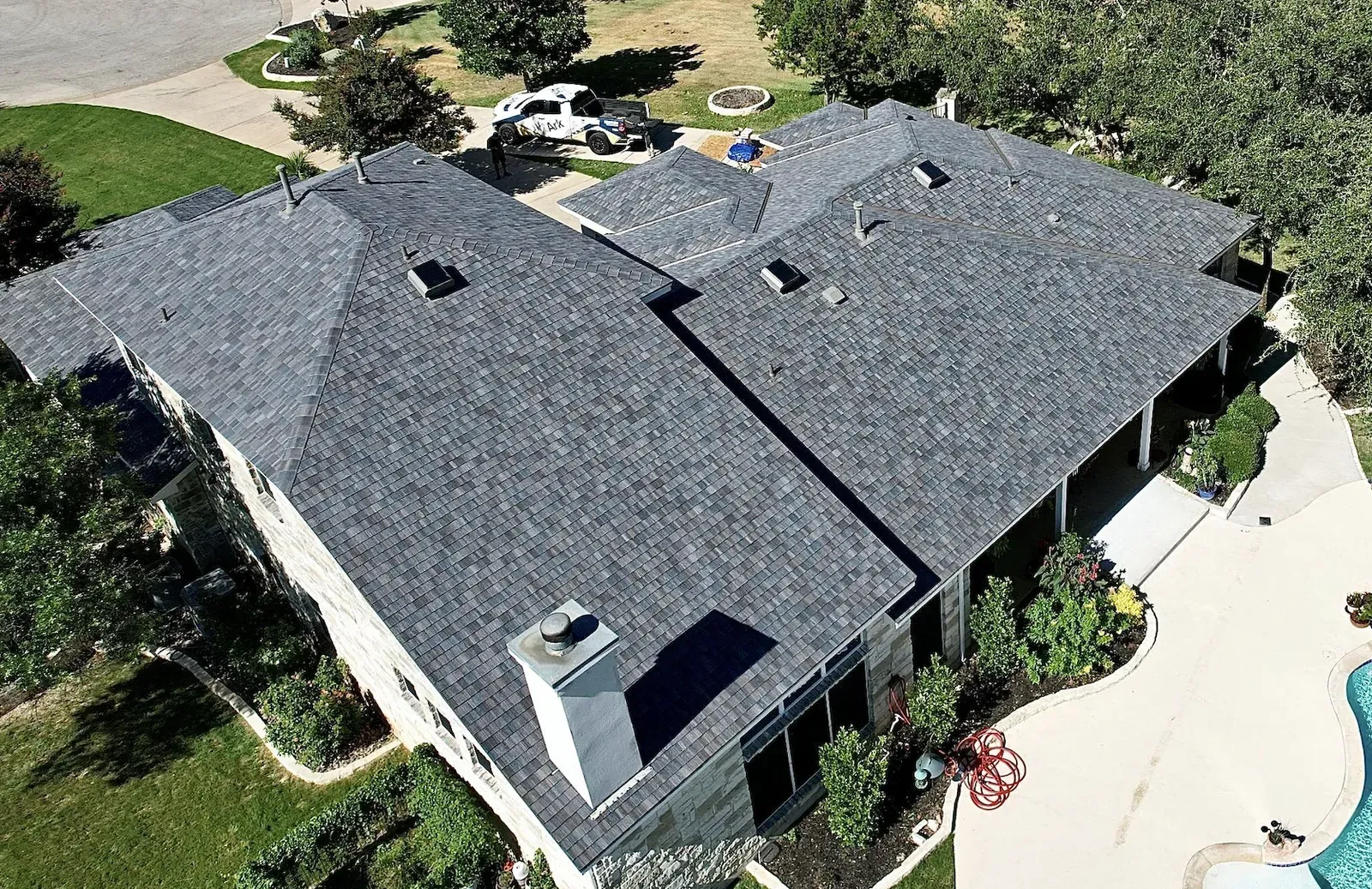 Synthetic slate roof installation from an aerial view