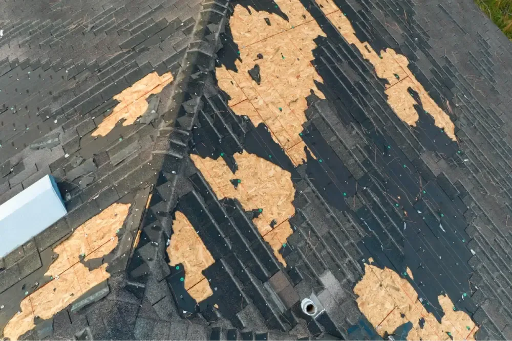 Old asphalt shingles stripped down to the roof decking on a Round Rock home